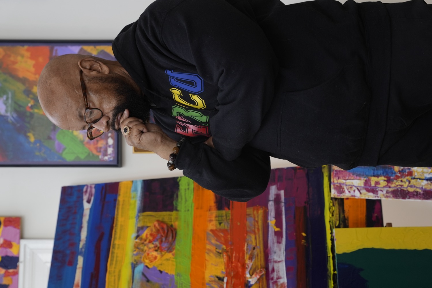 Bishop Donald Hilliard, Jr. standing with his artwork.